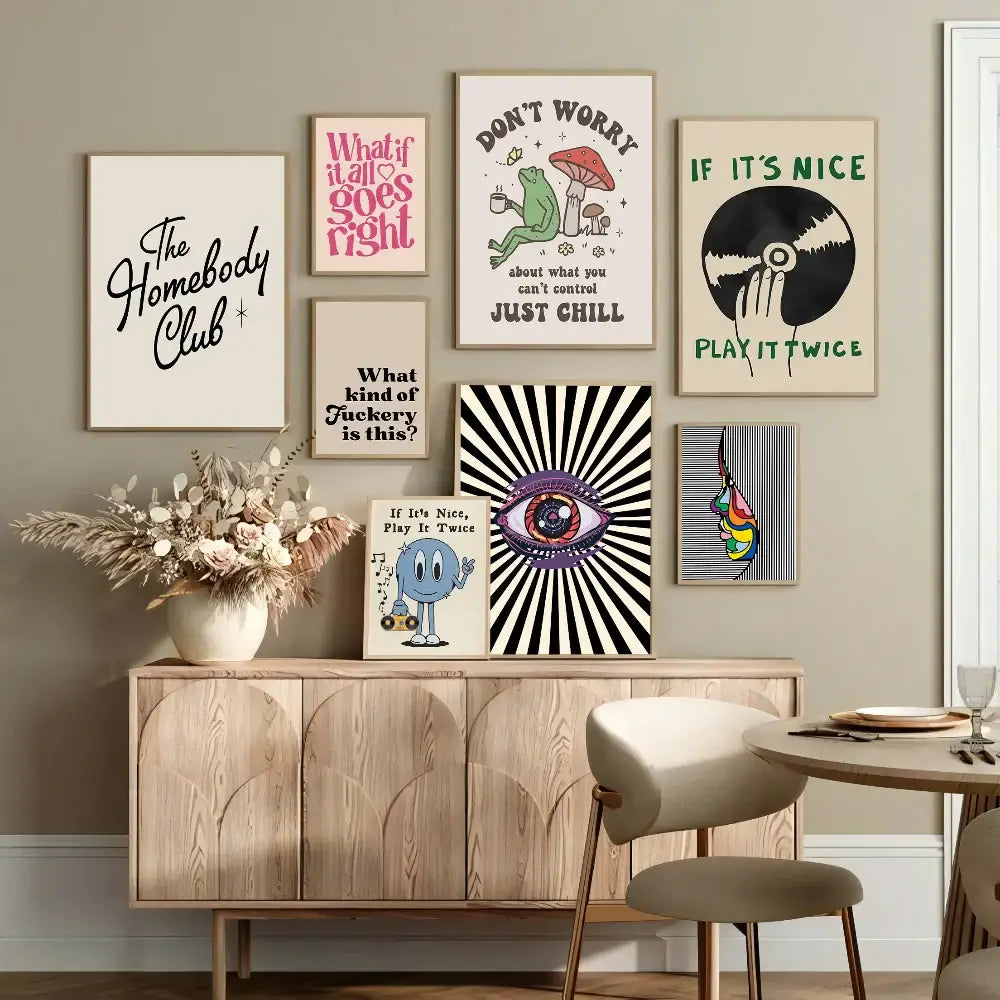 A collection of framed vintage pink cartoon print posters with colorful typography displayed above a wooden console table