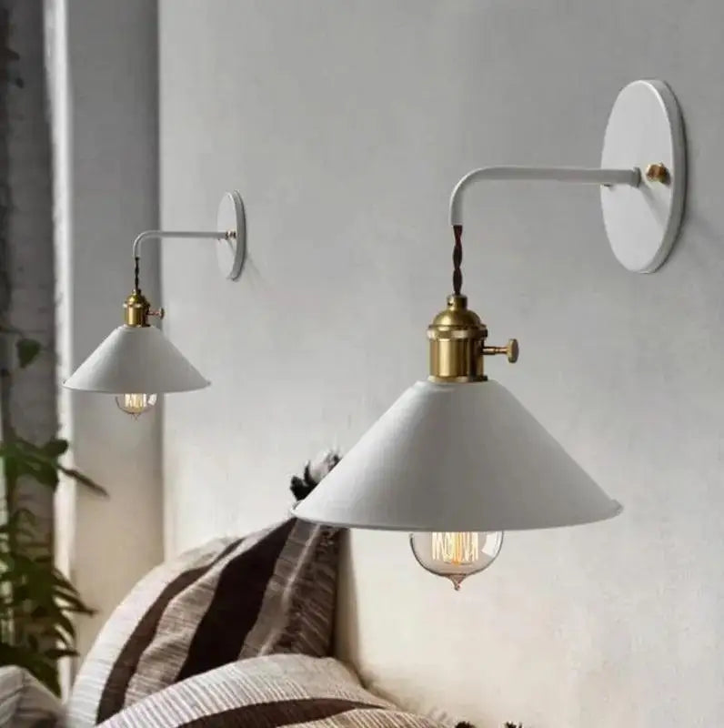 White conical shade vintage plated wall lamp with brass accents and visible filament bulb by decorbites