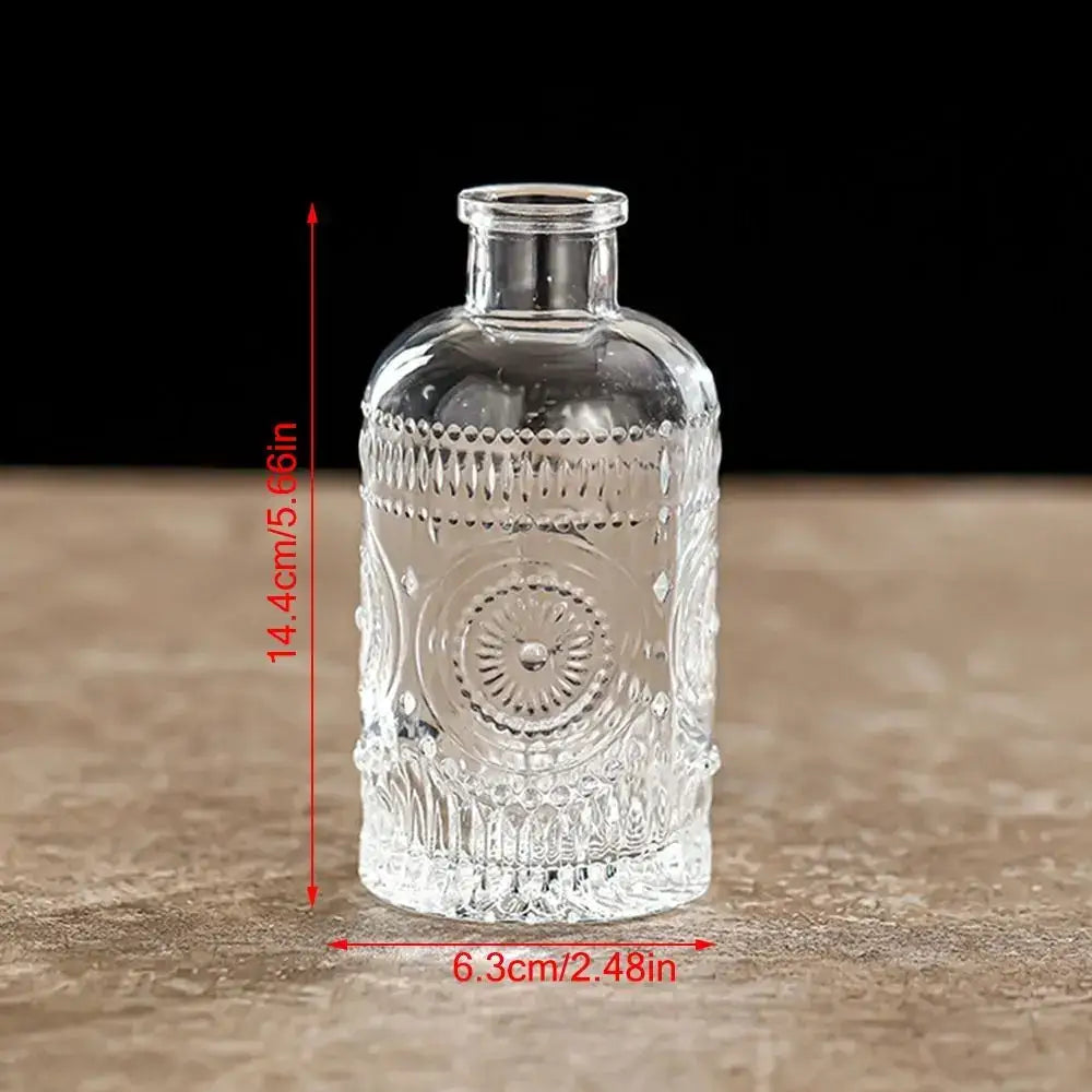 Clear glass vintage relief vase with intricate embossed patterns and narrow neck for hydroponic plants by decorbites