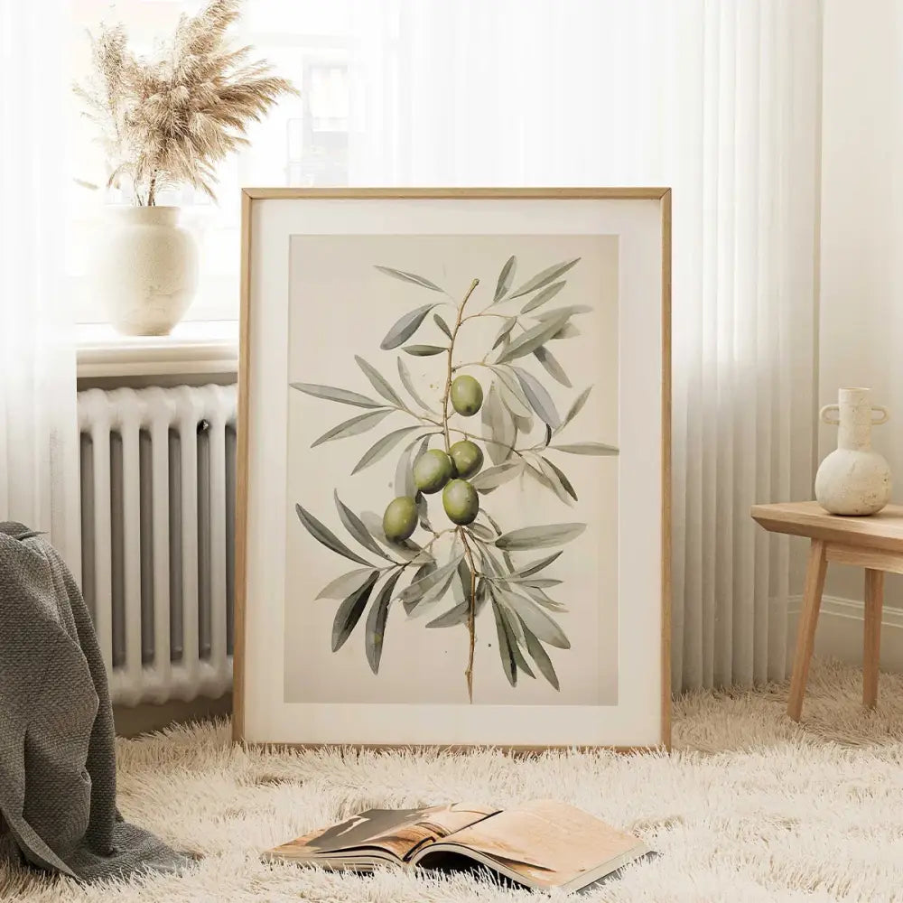 A framed vintage watercolor olive branch print with green olives and detailed leaves in a light wood frame by DecorBites