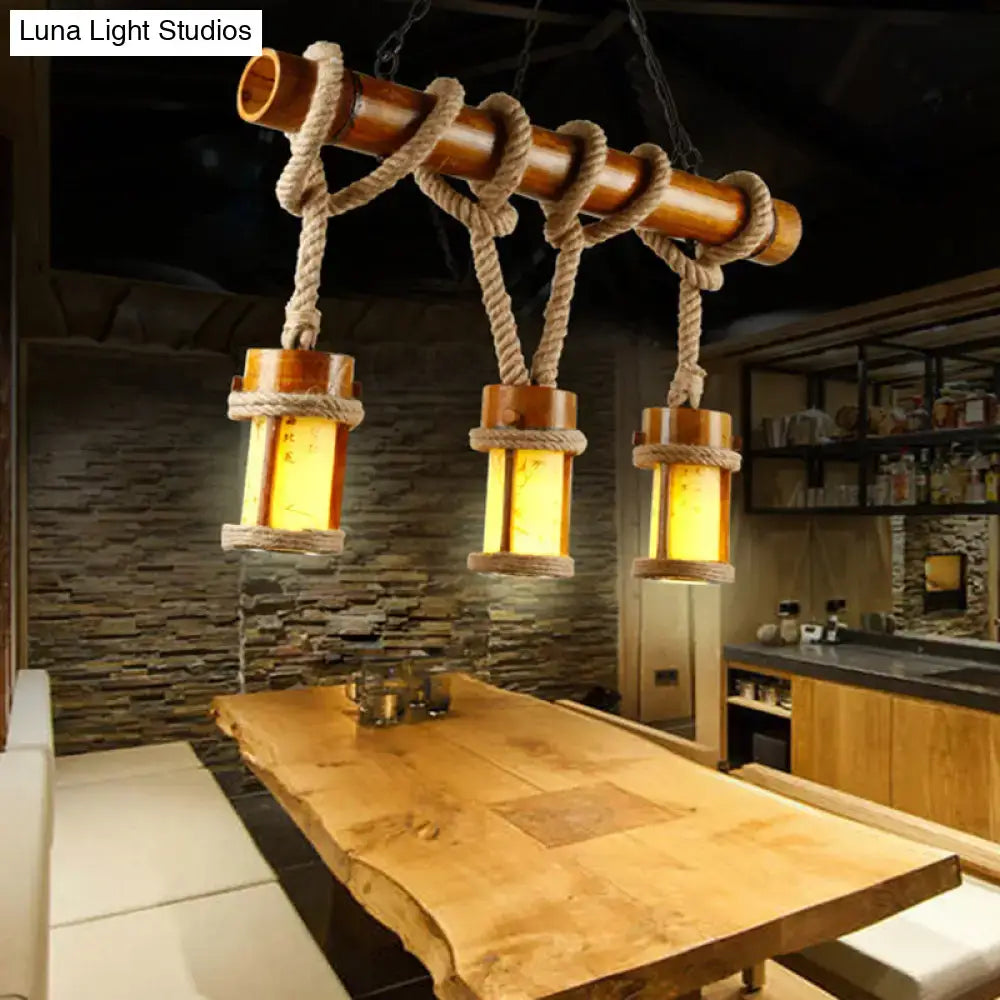 Rustic bamboo pendant light with three warm-toned lanterns suspended by rope cord compatible with 110v-120v and 220v-240v