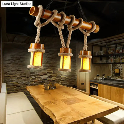 Rustic bamboo pendant light with three warm-toned lanterns suspended by rope cord compatible with 110v-120v and 220v-240v