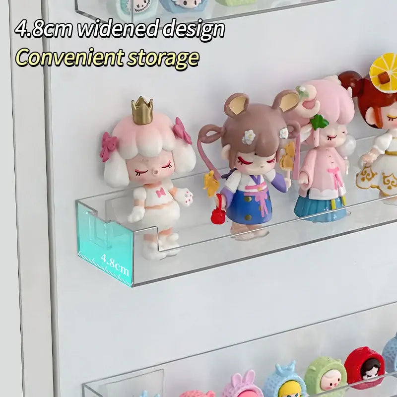 DecorBites wall mounted transparent storage rack in clear acrylic with 4.8cm widened shelf displaying figurines
