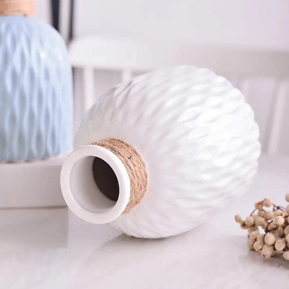 White ceramic decorbites™ ripple plastic vase with textured diamond pattern and natural twine wrap in modern nordic style