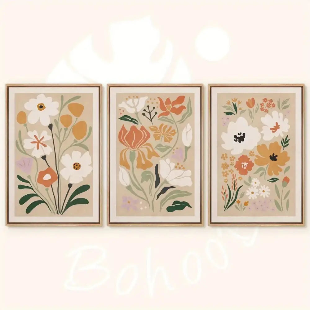 Set of three framed watercolor flower posters featuring stylized white orange and green flowers on beige canvas