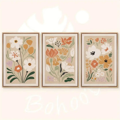 Set of three framed watercolor flower posters featuring stylized white orange and green flowers on beige canvas