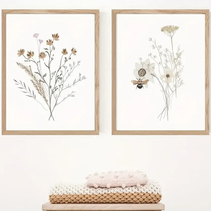 Two framed DecorBites™ watercolor flower posters with delicate floral and bee illustrations in light wood frames