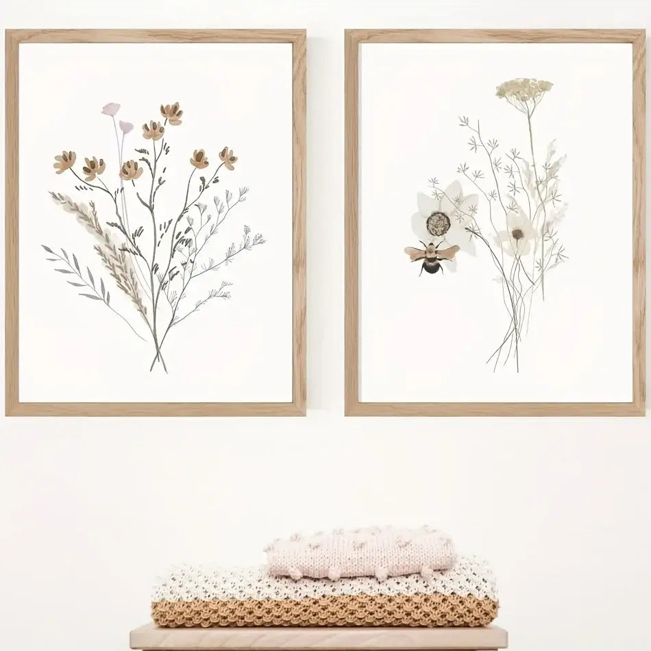 Two framed DecorBites™ watercolor flower posters with delicate floral and bee illustrations in light wood frames
