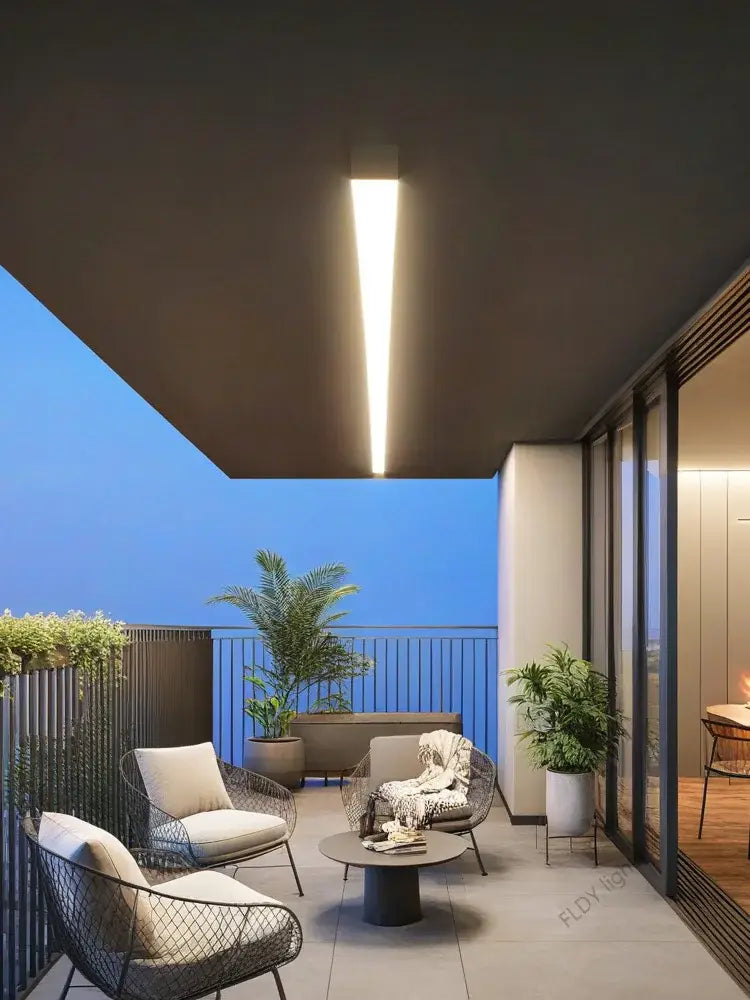 Modern black wireframe chairs with cream cushions beside decorbites waterproof led outdoor wall light with long strip led