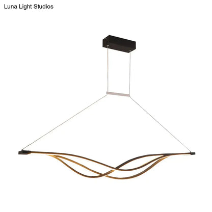 Modern gold-toned wave shaped metal LED island light fixture with sleek design and black rectangular ceiling mount