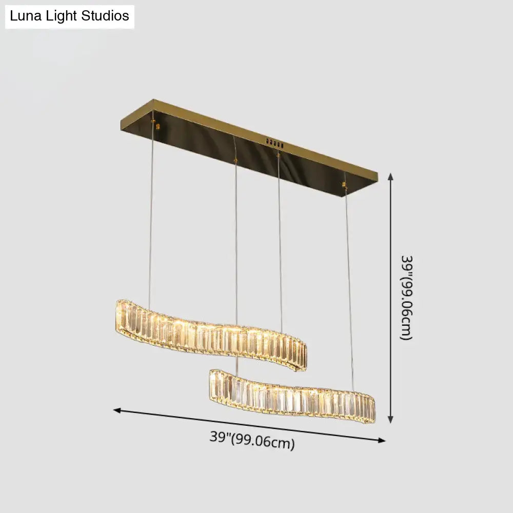 Gold-toned rectangular ceiling fixture with two curved illuminated prismatic crystal chandeliers for restaurants in brass finish