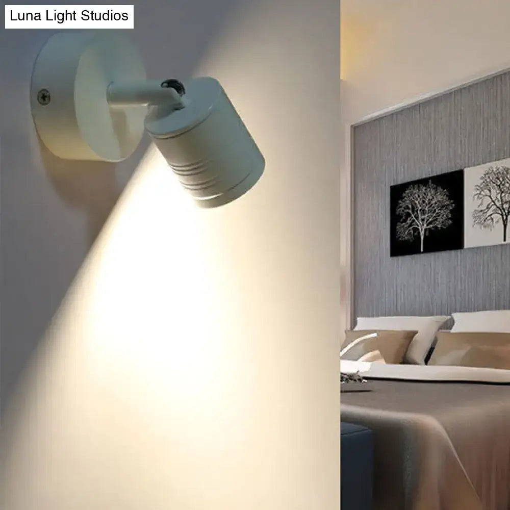 Modern ribbed white wall sconce lamp with adjustable spotlight head providing warm white light for bedroom use