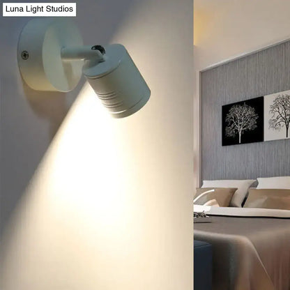 Modern ribbed white wall sconce lamp with adjustable spotlight head providing warm white light for bedroom use