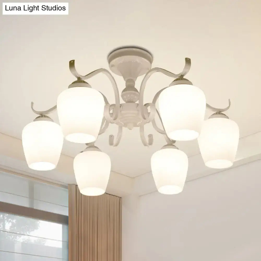 White chandelier with five frosted opaline glass cone shades and ornate metal arms in countryside style design