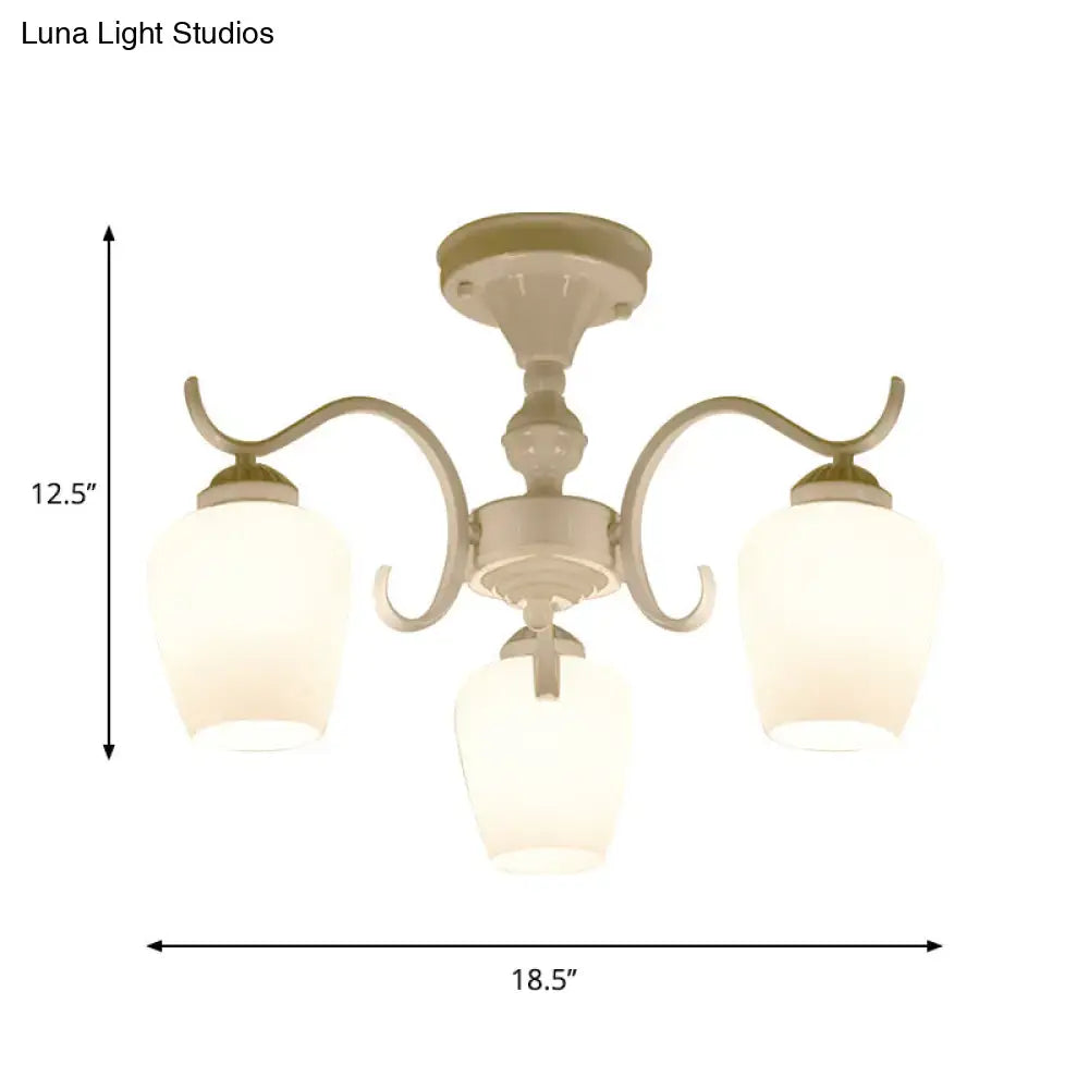 Cream-colored DecorBites chandelier with three curved arms and frosted opaline glass cone shades in countryside style