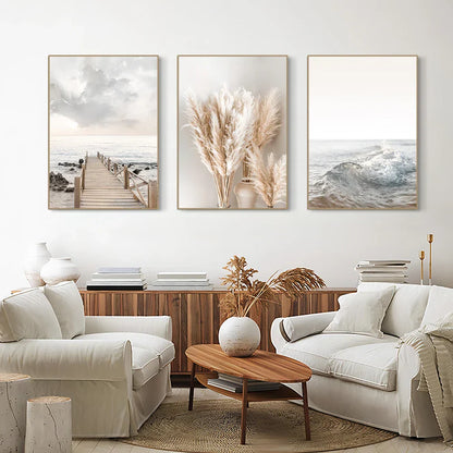 Set of three framed decorbites™ white seascape canvas prints featuring coastal and pampas grass in muted earthy tones