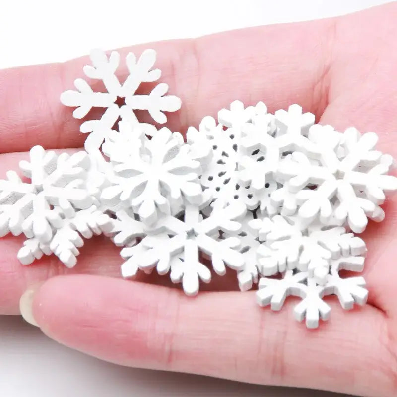 White wooden snowflake slices with intricate cut-out designs for christmas crafts by decorbites wooden slice ornaments