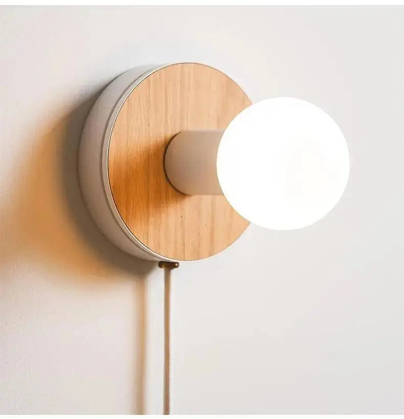 Minimalist decorbites wood plug-in wall sconce by bo-ha with circular wooden backplate and matte white housing glowing bulb