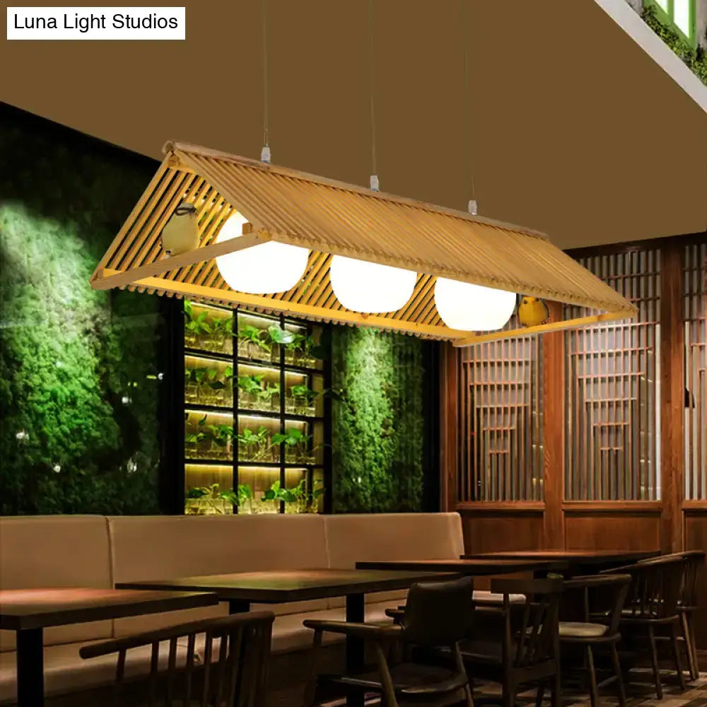 DecorBites wooden Asian triangle island pendant light in natural wood finish with slatted roof and three glowing bulbs