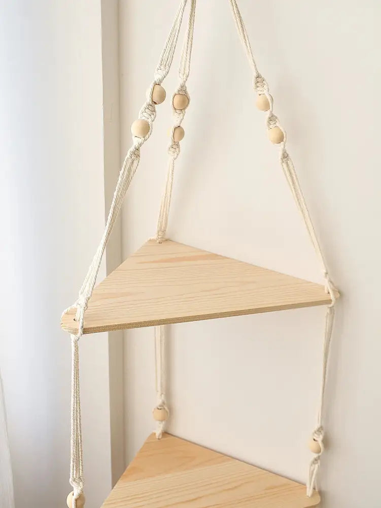 Beige macrame wooden corner shelf with light wood triangular shelves and wooden beads by DecorBites™ boho wall decor