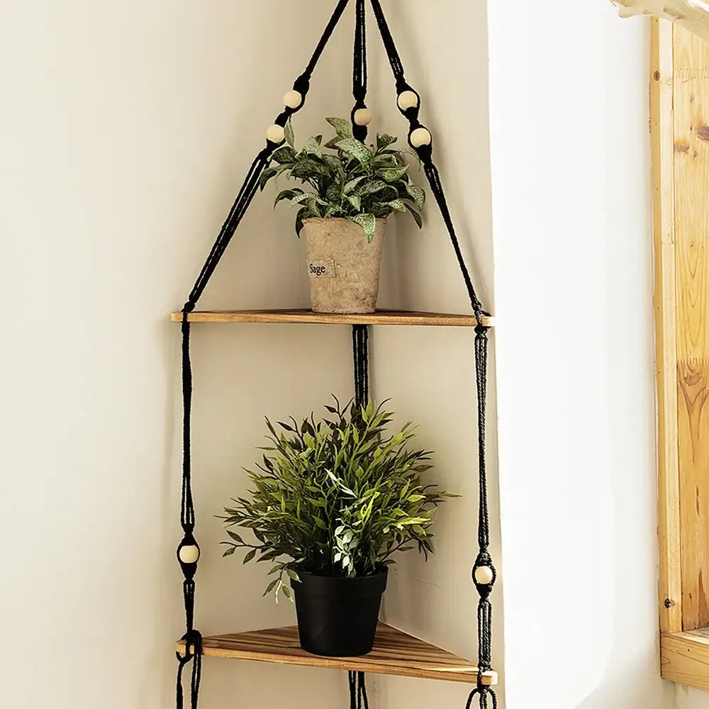 Black macrame hanging wooden corner shelf with wooden tiers and cream-colored beads for boho wall decor