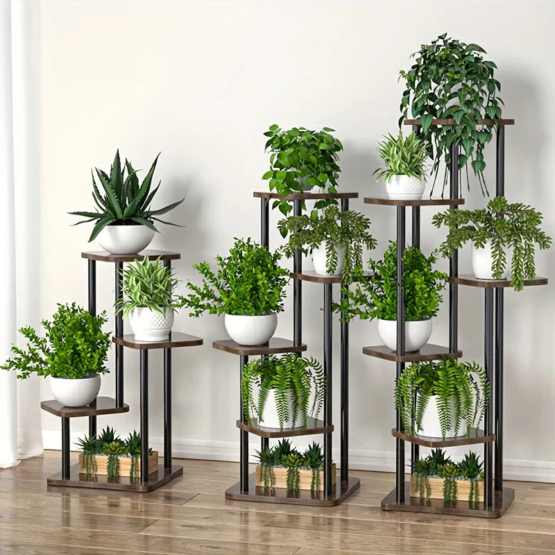 Set of three tiered DecorBites™ wooden flower plant stands with dark brown shelves and black metal frames holding green plants