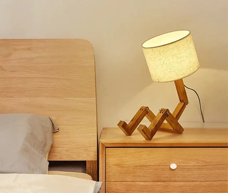Wooden robot shape creative table lamp with beige textured fabric shade for indoor study and reading