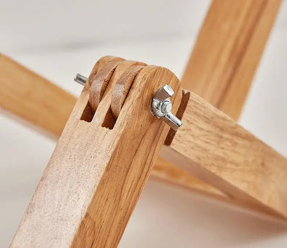 Light-colored wooden easel with silver wing nut securing joints for decorbites wooden robot shape creative table lamp