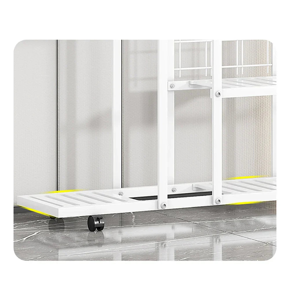 White metal rolling shelf with yellow accents and black wheels in a DecorBites wrought iron plant stand with wheels