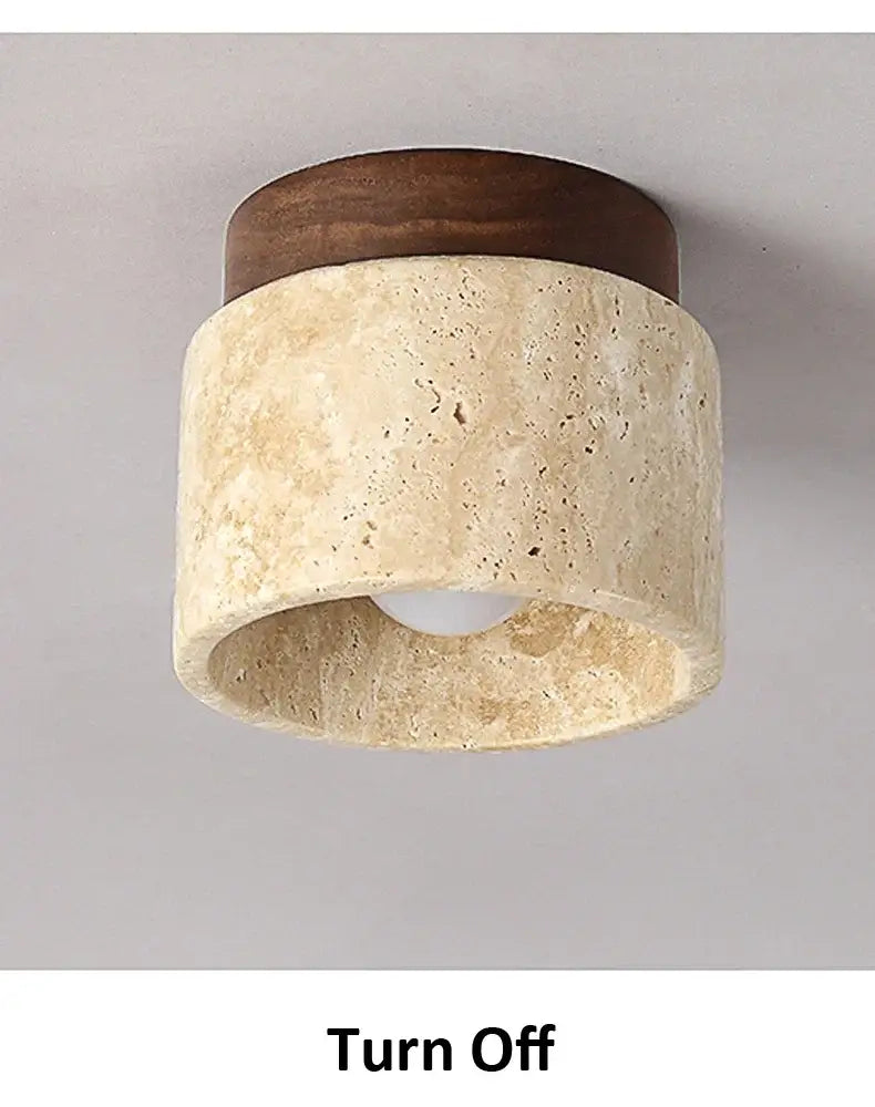 Rounded ceiling light with dark wood top and textured yellow marble stone body for home or commercial spaces