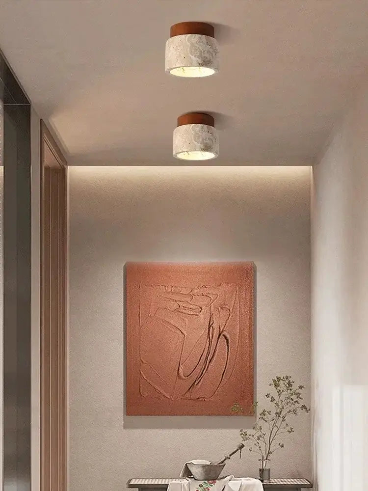 Two cylindrical decorbites™ yellow marble ceiling lights with textured white marble body and warm brown wooden top
