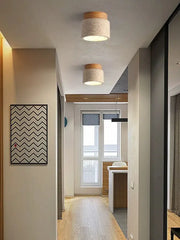 Two cylindrical ceiling lights with beige fabric shades and wood tops from decorbites yellow marble ceiling light collection