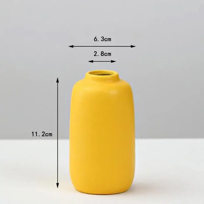 A sleek matte yellow porcelain flower vase with rounded body and narrow neck for elegant home decor by decorbites
