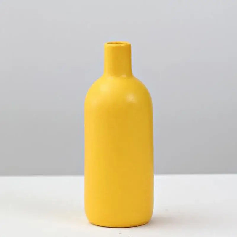 A sleek matte yellow porcelain flower vase by DecorBites for elegant home decor and floral arrangements