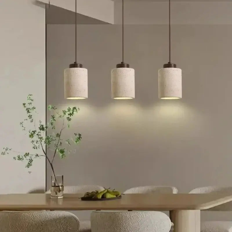 Three cylindrical concrete led pendant lights with warm diffused illumination in decorbites yellow stone chandelier