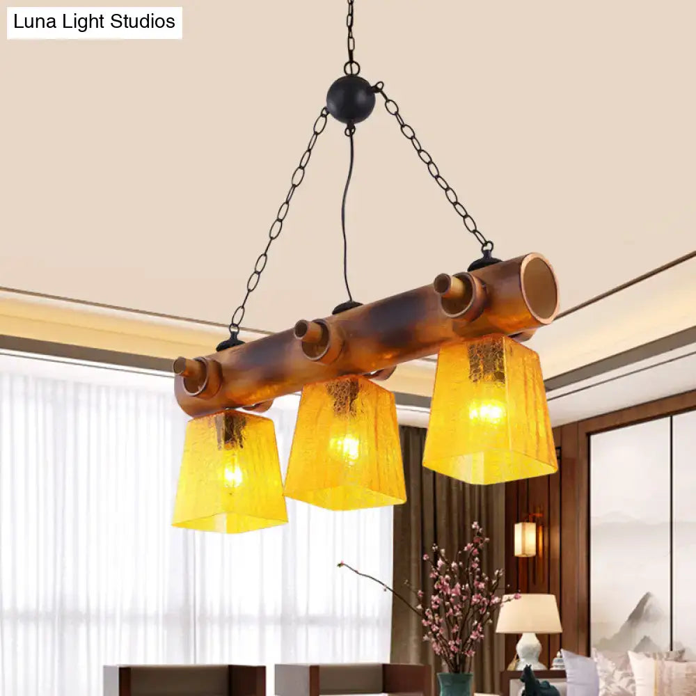 Decorbites™ yellow trapezoid island pendant light with 3 amber yellow water glass shades and rustic copper pipe frame for dining rooms