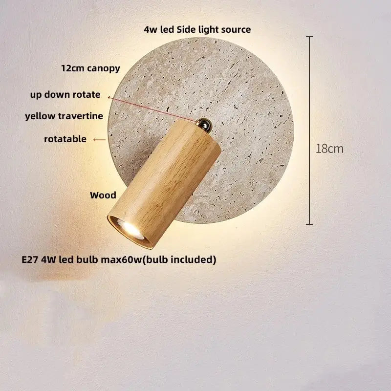 A cylindrical wooden wall sconce with natural finish mounted on a circular yellow travertine decorbites wall sconce canopy