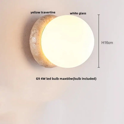 Modern wall sconce with a textured yellow travertine base and smooth white glass globe for bedroom lighting decorbites yellow travertine