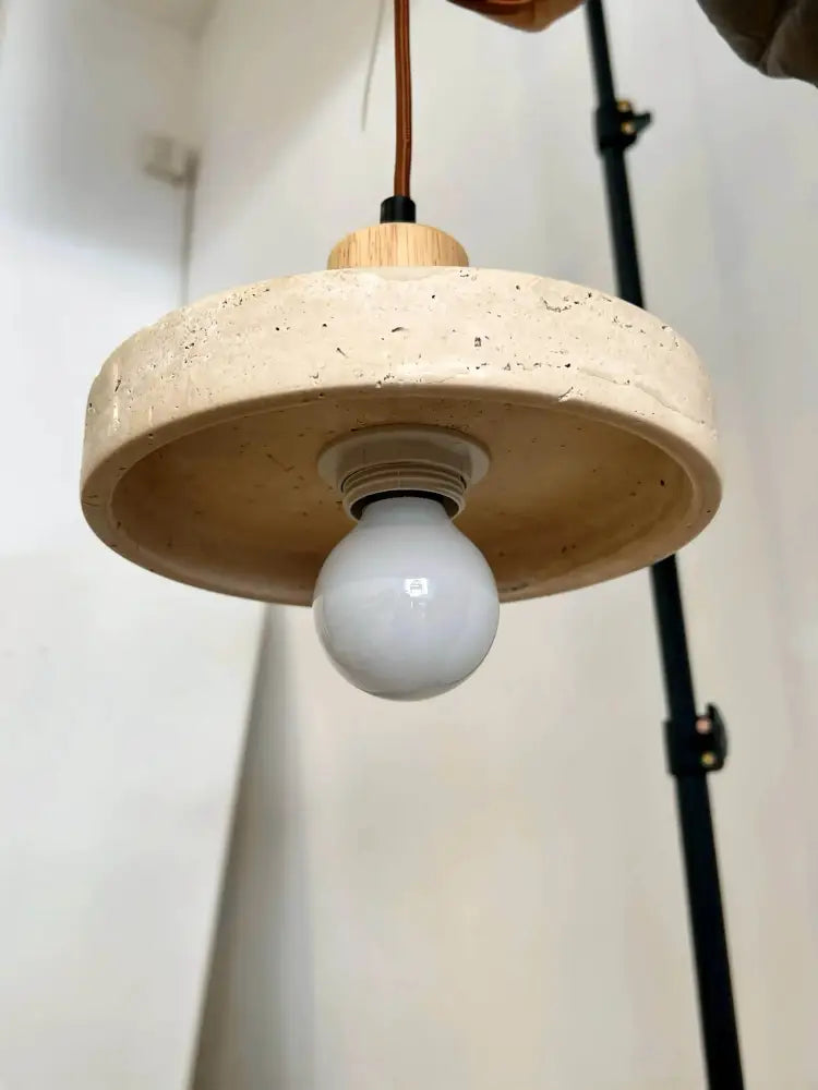 Decorbites yellow travertine pendant light with circular textured beige stone pendant shade and wooden top for kitchen island