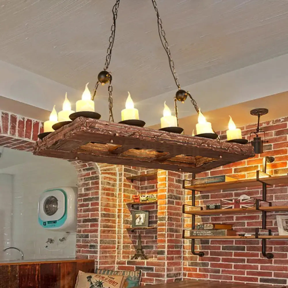 Rustic yellow wood island pendant light with six lit e12 e14 candle-style bulbs and dark metal chains by DecorBites