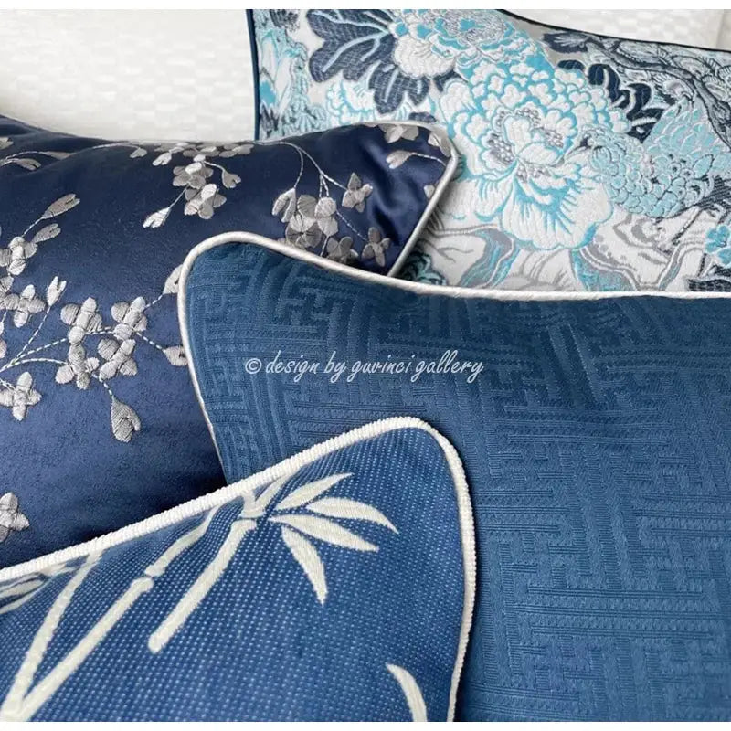 Deep blue geometric jacquard cushion cover with intricate silver floral embroidery and white piped edge for living room decor