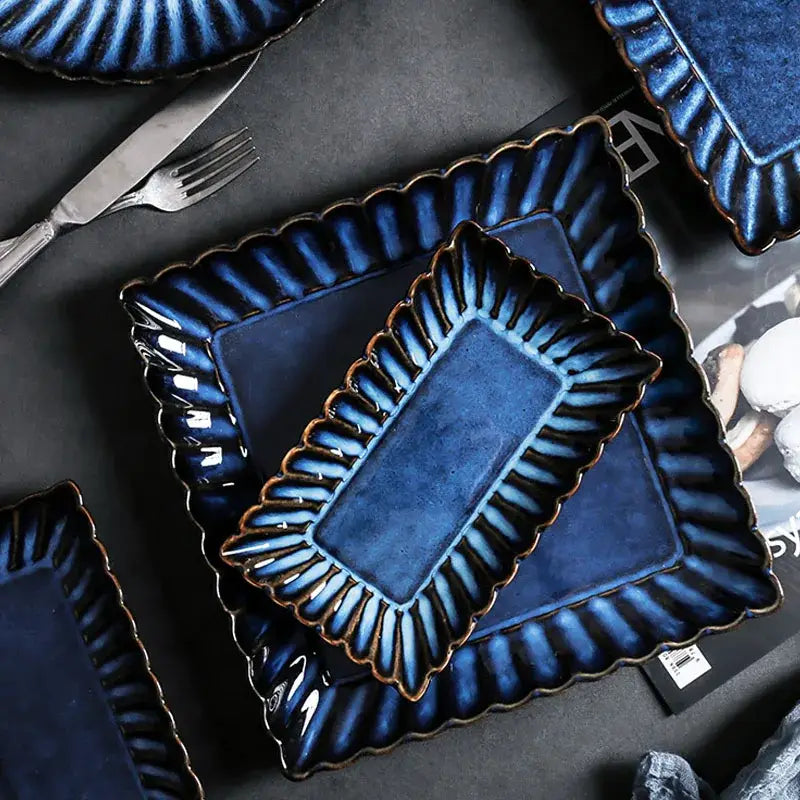 Deep blue klin glazed ceramic rectangle sushi tray with glossy scalloped edges and subtle gold-toned accents