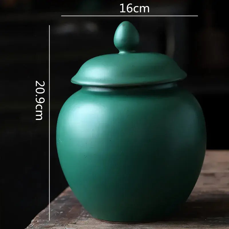 Deep green ceramic tea caddy jar with matte finish rounded body and lid for kitchen storage container