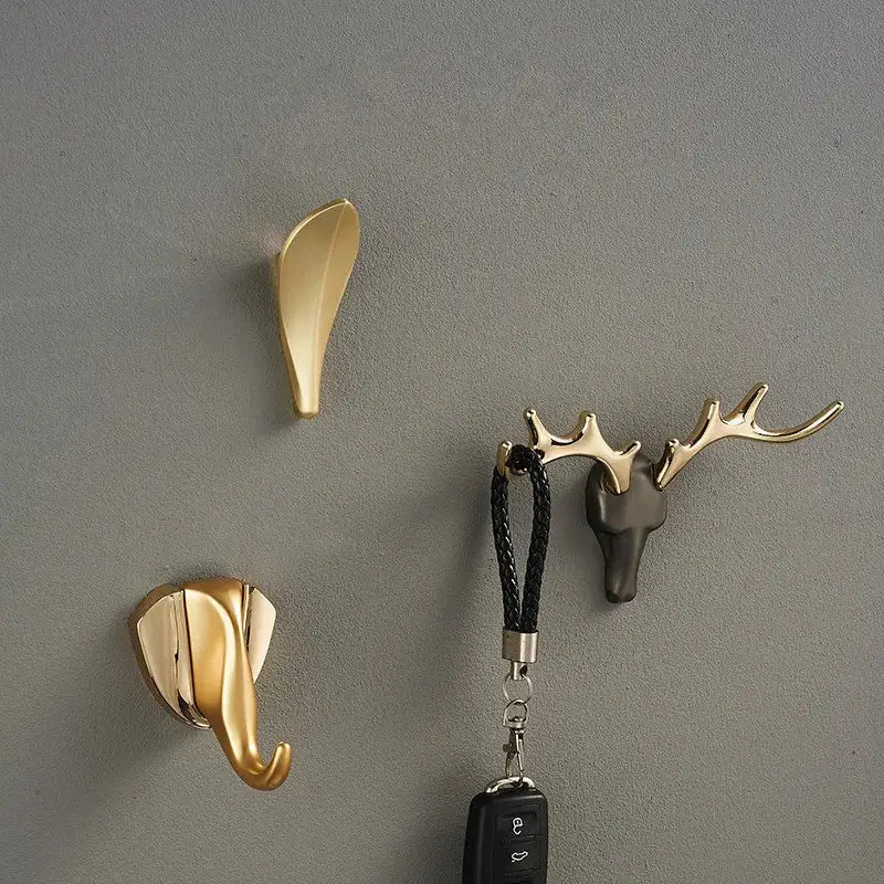 Gold brass wall mount robe hooks including deer antler, elephant head, and leaf shapes for decorbites brass wall use