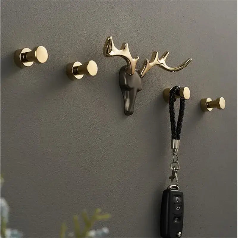 Gold-toned deer antler brass wall mount with dark gray skull base robe hook for bathroom towel holder decorbites brass wall