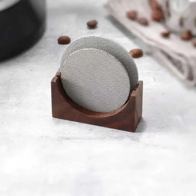 Denim blue and black silver mesh coasters with decorbites espresso puck screen in a dark wood kitchen holder stand
