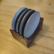 Set of four denim blue and black coasters with espresso puck screen in a wooden holder for decorbites espresso puck use