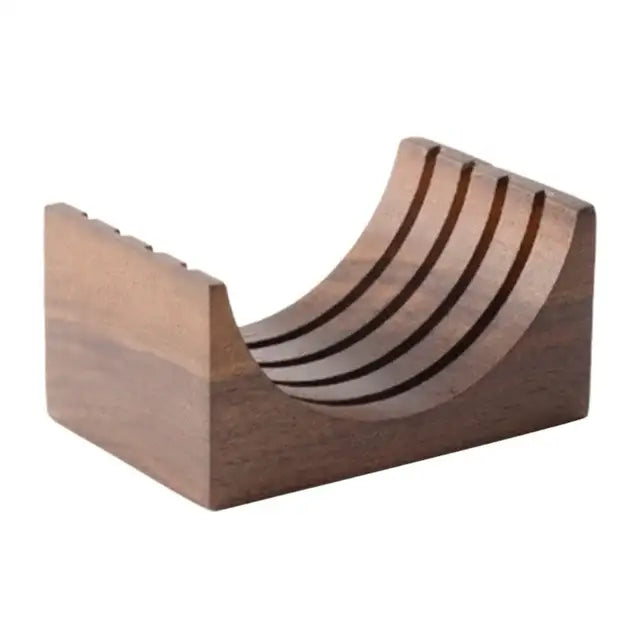 Dark brown wooden knife block with curved design and five slots beside denim blue and black decorbites espresso puck screen coasters