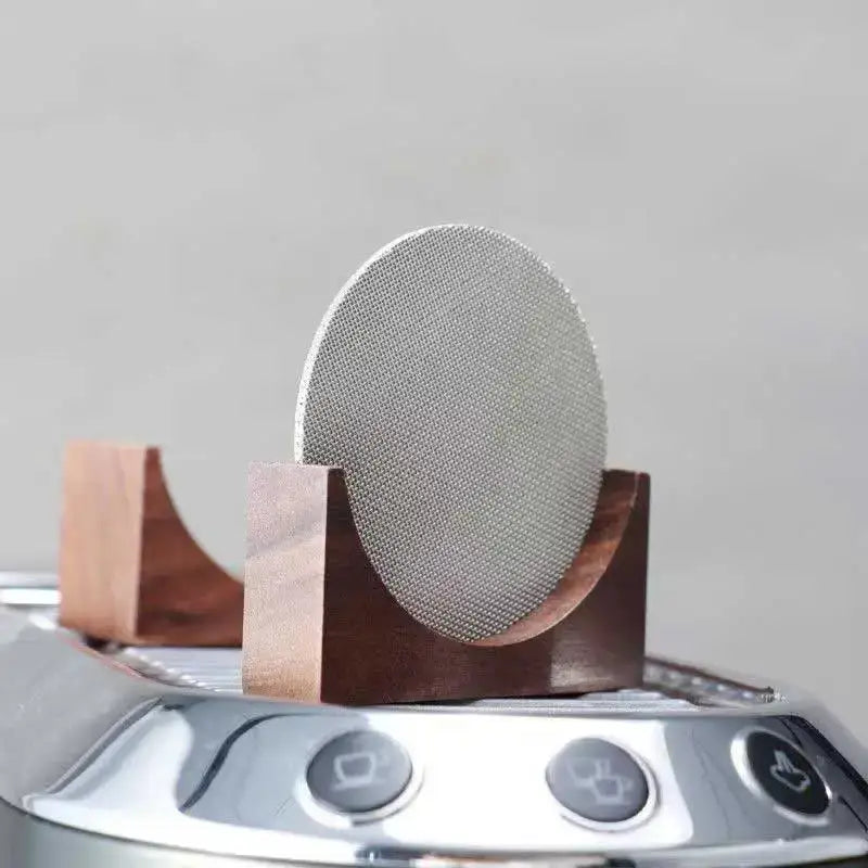 Denim blue and black coasters with espresso puck screen featuring a silver mesh puck screen in a dark wood stand