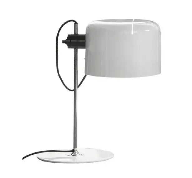 A sleek white cylindrical lampshade with polished chrome stand and black cord designer nordic coupe table lamp